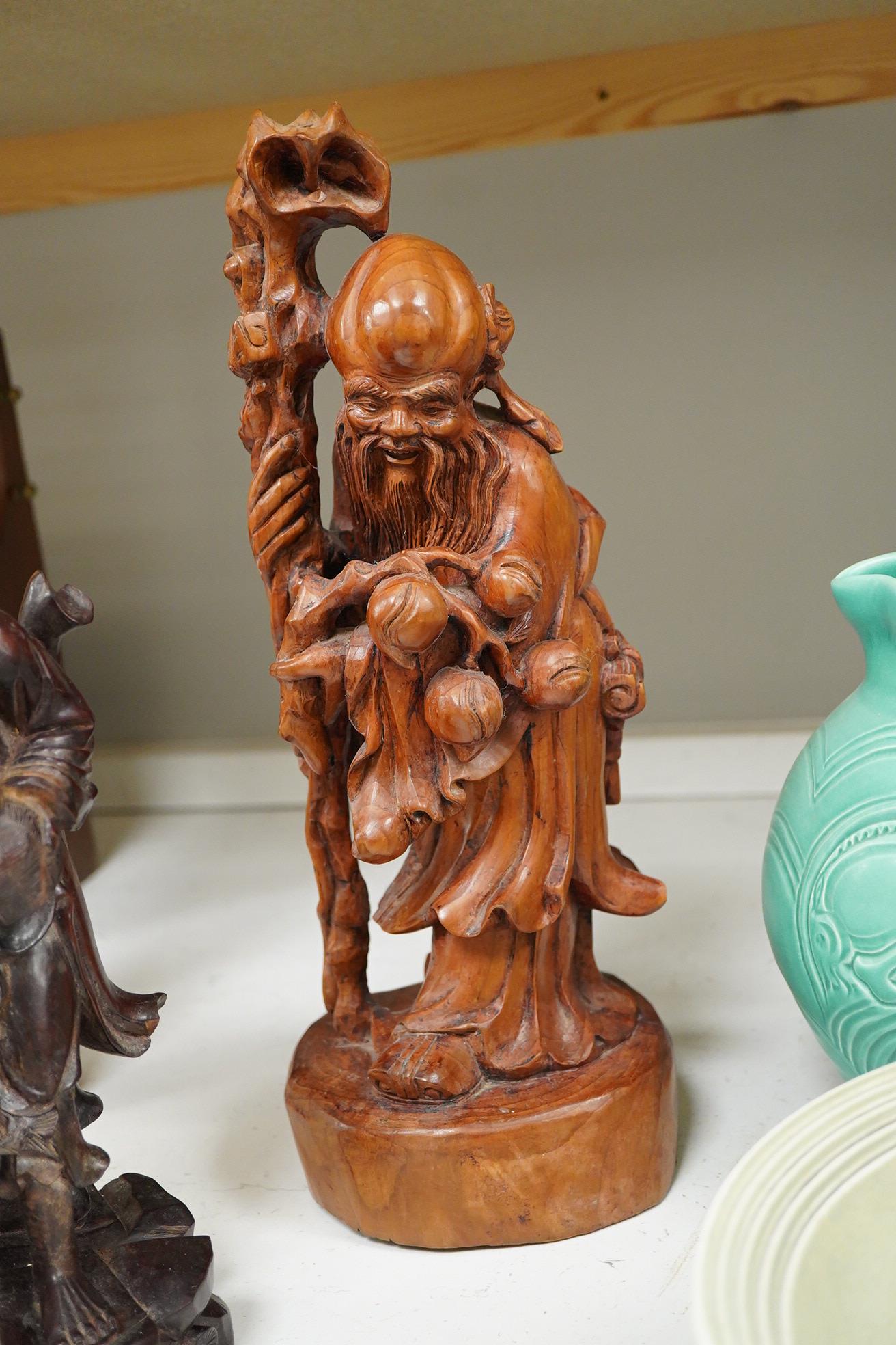 Three Chinese carved wood figures; Shou Lao, a fisherman and a Luohan, tallest 39cm